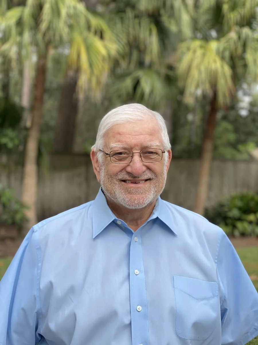 Michael Martin smiling in a blue button-down shirt